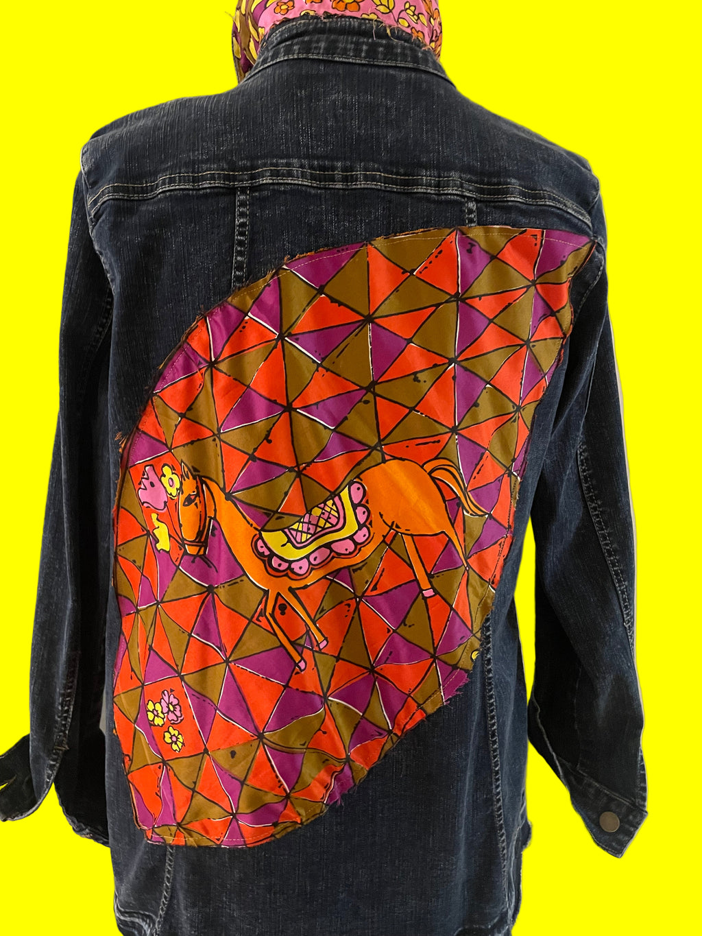 Colorful geometric-pattern with a horse design on a dark blue denim background